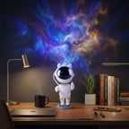 Astronaut Galaxy Projector on a desk projecting a nebula across the wall